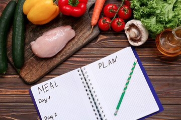 Wall Mural - Healthy products and weekly meal plan on wooden background. Diet concept