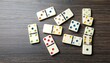 © alfa - Dominoes Game Pieces on Wooden Table.