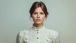 © pinporn manosri - Portrait of a young woman in vintage clothing with a neutral background, showcasing classic beauty and elegance in a soft light, emphasizing natural features and timeless fashion