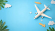 © Poramet - Flat lay design of travel concept with plane and cloud on blue background with copy space
