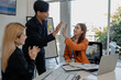 © Chadaporn - the group of business people showed their joy by clapping and giving high fives because of their success in business, joyful, cheerful, brainstorming in the meeting room, businessman