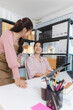 © Imagestoyou - Two young women work together in a small business office, surrounded by shipping boxes and documents. They discuss orders, prepare packages, and manage inventory on a computer.