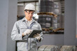 © Surachai - Industrial worker using tablet for inventory management in warehouse technology indoor professional efficiency