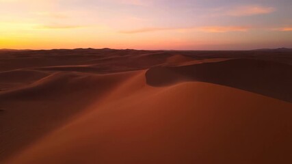 Wall Mural - Sweeping Drone Shot Over Vast Undulating Sand Dunes with Wind Patterns at Sunset cinematic, desert, majestic