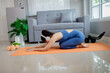 © Pang - Young woman practicing yoga indoors, sitting in lotus position with calmness, balance, and focus, promoting health, relaxation, and wellness.