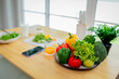 © Pang - Woman holding fresh salad bowl with vegetables, promoting healthy eating, organic lifestyle, and balanced diet in a colorful kitchen setting.