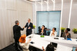 © artitwpd - Diverse colleagues applaud as two professionals shake hands in modern conference room. Business meeting scene shows partnership, sales, leadership, planning, collaboration, and networking seminar.