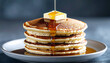 © Hanz013 - A delicious stack of fluffy pancakes with melting butter and dripping maple syrup.