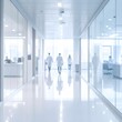 © Lavo - Abstract, blurred hospital corridor with medical staff walking towards a bright window. Clean, sterile, and modern environment