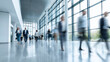 © Curioso.Photography - People walking in modern office hallway with motion blur.