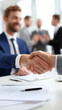 © Curioso.Photography - Businessmen shaking hands after successful meeting in office.