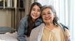 © Art_Photo - Portrait of enjoy happy love asian family senior mature mother and young daughter smiling play laughing and having fun together at home, care, elderly, insurance.happy family and Mother Day concept