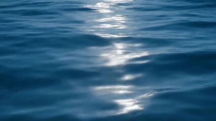 Wall Mural - Subtle changes in light on reflecting ocean waves from an overhead perspective timelapse surface, sea, liquid