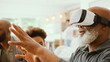 © Monkey Business - Grandfather Wearing VR Headset As Multi-Generation Male Family Sit On Sofa At Home Together