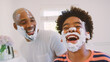 © Monkey Business - Father And Son At Home Having Fun Playing With Shaving Foam In Bathroom Making A Mess Together