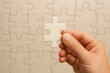 © AbdulRauf - Hand holding jigsaw puzzle piece teamwork concept
