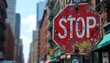 © miss irine - Urban stop sign with graffiti art in city street against background of buildings. Traffic sign on pole, weathered, day. Roadside sign with direction, safety, warning message.