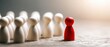 © Boh - The Red Pawn Standing Before a Line of White Wooden Figurines Signifying Leadership