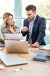 © Bojan - Businessman and businesswoman are commenting document while working together on project