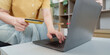 © Natee Meepian - Online Shopping. Close-up of woman using credit card on laptop for e-commerce.