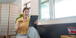 © Natee Meepian - Online Shopping: Happy woman making purchases with credit card and tablet at home