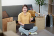 © Natee Meepian - Online Shopping. Young woman smiling while using laptop and holding credit card at home.