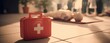© shen - The first aid kit in foreground with CPR dummy and training class background