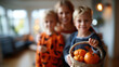 © Kateryna - Group children wearing Halloween costumes home indoor setting family living room pumpkin decorations Halloween home decorating family costume themes blurred background with copy