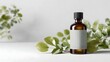 © Bussakon - Brown glass bottle with a blank label and green leaves on a white background