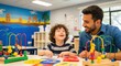 © BloomPix - Teacher Helping a Young Boy with Educational Toys. A smiling teacher assists a young boy with curly hair as he plays with colorful educational toys at a table in a bright, decorated classroom