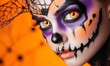 © VictoriaEmerson - Woman wearing vibrant halloween makeup with glowing orange eyes and spiderweb details