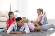 © New Africa - Happy family with children on floor at home