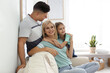 © New Africa - Happy family with daughter on sofa indoors
