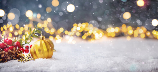 Wall Mural - christmas holiday background with snow, fir tree and decorations with christmas light behind. christ
