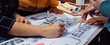 © InfiniteFlow - A diverse team engages in a collaborative design session, working together on detailed architectural blueprints and sketches while brainstorming innovative ideas. SACTR