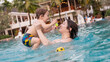 © Михаил Решетников - Caucasian woman holds her son while swimming in a pool on vacation. Mom teaches little boy to swim.