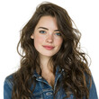 © Vibu design  gallery - A young woman with long brown wavy hair and blue eyes smiles gently at the camera, wearing a denim jacket against a transparent background. background removed