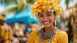 © dominic - Brightly dressed woman wearing floral crown and yellow outfit smiling warmly at outdoor cultural event with lush greenery and vibrant atmosphere in background.