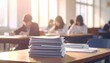 © Fauzan - Exam answer sheet pile, blurry application document paperwork stack on office work table in examination room or classroom with blur education background school class university students taking test