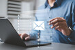 © Garun Studios - Business professional using digital email communication system for online messaging, business contact, and email marketing.