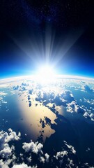 Wall Mural - Stunning perspective of Earth from space with a brilliant sunrise over the atmosphere illuminating the planet and clouds