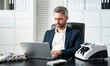 © Volodymyr - Businessman counting money at his office desk. Banker handling cash and bills in a corporate setting. Accountant organizing dollars and banknotes for finance management.