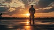 © RezaArif - Silhouette of soldier at sunset on tarmac with helicopters in background.