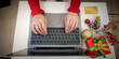 © Natee Meepian - Christmas Online Shopping. Overhead view of woman typing on laptop with credit card.