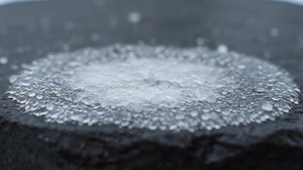 Wall Mural - Timelapse showing an icy crust forming and thickening on a cold surface from hail cold, detail, texture