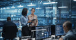 © Gorodenkoff - In a Modern Data Center, Caucasian Female Data Scientist and Asian Female AI Specialist Analyze Algorithms on a Tablet Computer. Specialists Exploring Optimizations for Processing Large Datasets