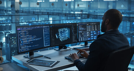With Multiple Screens Open to Code and Analyze Neural Network Visualizations, African Software Developer in a Data Center Refines an AI Algorithm, Working Methodically to Improve the Product