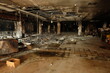 © onyengradar - Burnt interior shows devastation after fire in commercial building, revealing charred debris and structural damage with somber atmosphere.