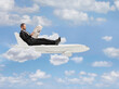 © Ljupco Smokovski - Businessman sitting on a plane and reading a newspaper