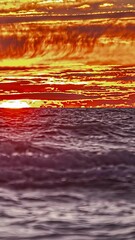 Wall Mural - Timelapse Of Sunrise Across Fiery Sky Over Ocean - Vertical Shot
